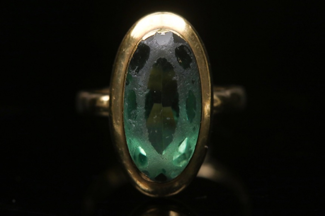 Golden ring with green glass stone